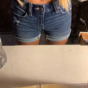 like a dark wash american eagle jean shorts with a rip on the side